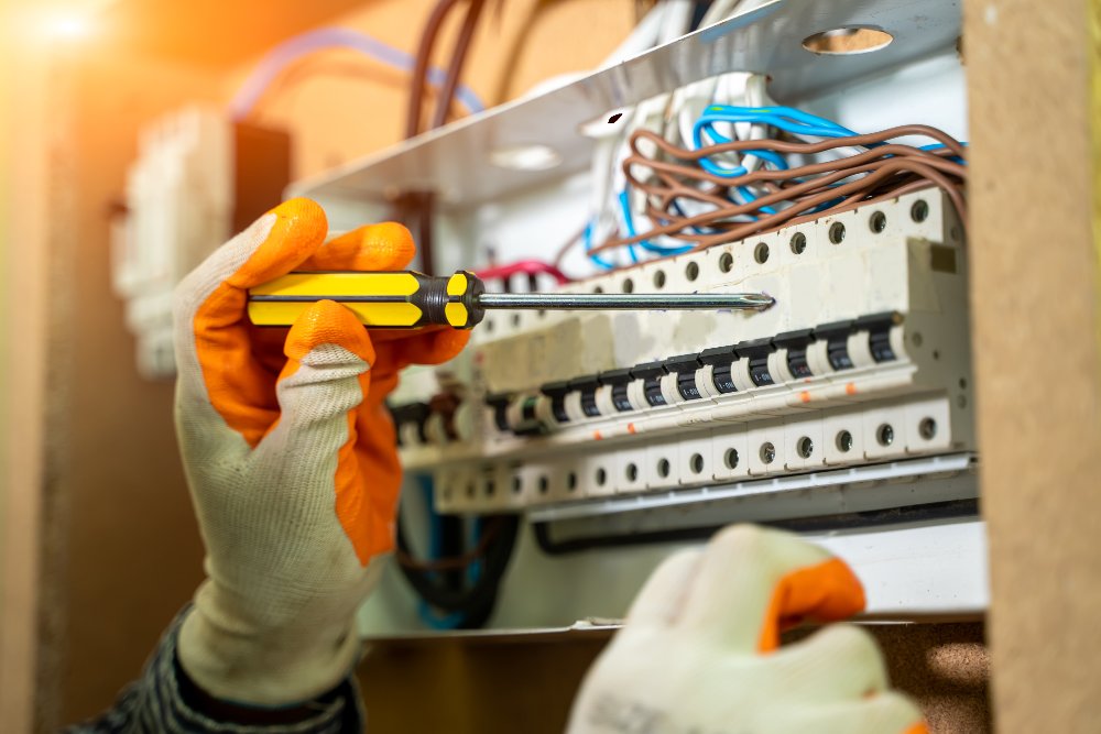 Electrician Installing Socket In New House,Electrician working safely on switches and sockets of a residential electrical system.